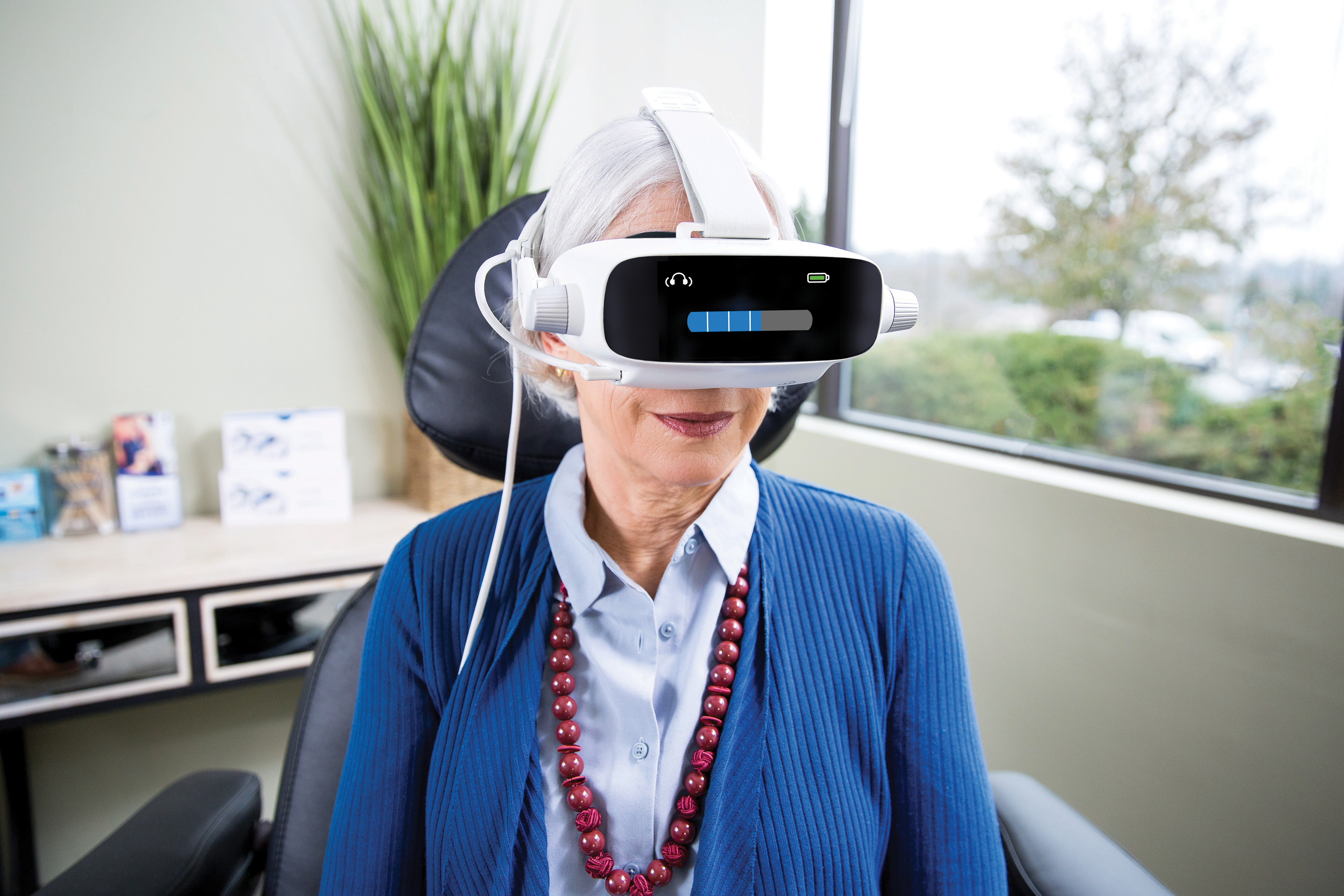 Technician holding AdaptDx Pro headset in her hand